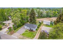 Charming home with a spacious yard, mature trees, and a private setting, perfect for outdoor living and entertaining at 8450 W 13Th St, Lakewood, CO 80215