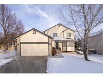 Two-story house with attached garage and snowy front yard at 4632 S Ensenada St, Centennial, CO 80015