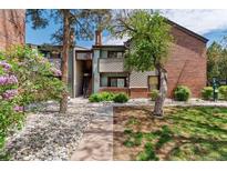 A charming two-story condo with well-maintained landscaping is surrounded by lush foliage at 11905 E Harvard Ave # 208, Aurora, CO 80014
