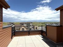 Enjoy this outdoor patio with tile floors and mountain view at 9627 Browns Peak Cir, Littleton, CO 80125