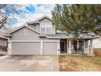 Charming two-story home with a well-manicured lawn, attached two-car garage, and welcoming front porch at 13421 Humboldt Way, Thornton, CO 80241