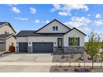 Charming two-story home with a three-car garage and beautifully landscaped front yard at 25204 E Warren Pl, Aurora, CO 80018