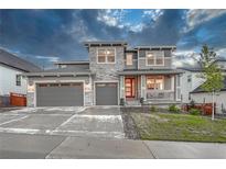 Charming two-story home featuring a three-car garage and inviting front porch at 2775 Morningbird Ln, Castle Rock, CO 80109