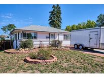 Charming single-story home featuring a well-manicured front yard and inviting entrance at 2141 W Gill Pl, Denver, CO 80223