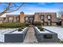 Charming townhome with a unique wood shake roof, brick accents, and manicured landscaping in a desirable location at 4032 S Olive St, Denver, CO 80237