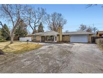 Charming single-story home with a brick exterior, attached garage and well-maintained grounds at 4585 Garrison St, Wheat Ridge, CO 80033