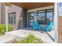 Charming front porch featuring a wreath on the door and two bright blue chairs at 2008 S Galapago St, Denver, CO 80223