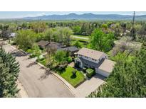 Charming home with mature trees, an attached two car garage, and a well manicured lawn, exuding curb appeal and comfort at 4667 Ashfield Dr, Boulder, CO 80301