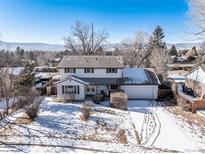 Charming two-story home featuring an attached garage, snow-covered lawn, and mature trees in a quiet neighborhood at 4667 Ashfield Dr, Boulder, CO 80301