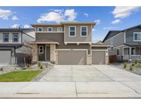 Charming two-story home featuring a two car garage, neutral color palette, and manicured landscaping at 45915 Wood Thrush Ave, Bennett, CO 80102