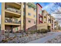 Attractive multi-story condo building with balconies and well-maintained landscaping at 1144 Rockhurst Dr # 401, Highlands Ranch, CO 80129