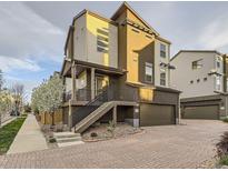 Contemporary home featuring mixed siding, a brick driveway, and an attached garage, steps, and a garden at 2564 Sweet Wind Ave, Castle Rock, CO 80109