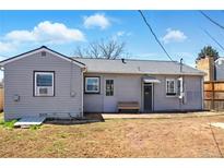 View of a charming backyard with a bench and access to the home's entrance at 764 S Osage St, Denver, CO 80223