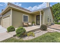 Charming front porch with seating and a welcoming entrance, complemented by fresh landscaping at 10239 W Fair Ave # A, Littleton, CO 80127