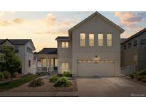 Charming two-story home with a front porch, attached garage and manicured landscaping at 4670 Tanner Peak Trl, Brighton, CO 80601