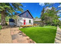 Charming home featuring a red door, manicured lawn, and inviting curb appeal at 1029 9Th St, Boulder, CO 80302