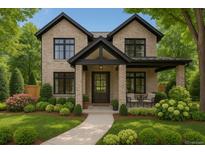 Charming two-story brick home with a beautifully landscaped front yard and inviting front porch seating area at 1149 S Madison St, Denver, CO 80210