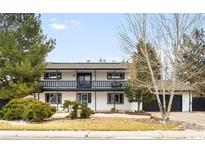 Two-story home with white siding, black trim, second story balcony, and manicured front lawn at 11210 Parliament Way, Parker, CO 80138