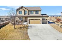 Two-story home featuring a spacious three-car garage, large driveway and covered porch at 16525 Sanford St, Mead, CO 80542