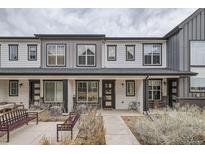 Inviting townhome featuring a well-manicured lawn and a charming front patio at 9269 Garnett St # C, Arvada, CO 80007