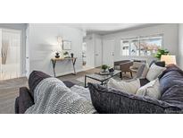 Inviting living room features a comfortable couch, lots of pillows and plenty of natural light at 2595 S Sheridan Blvd # 20, Denver, CO 80227