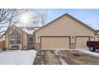 Charming single-Gathering home with a two-car garage and a well-maintained front yard, partially covered in snow at 1025 Birch Ave, Fort Lupton, CO 80621