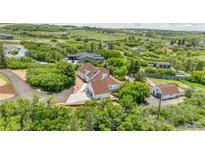 Stunning aerial view of a home and surrounding landscape with mature trees and a long driveway at 9053 Clydesdale Rd, Castle Rock, CO 80108