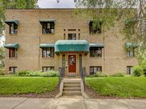 Charming brick apartment building with green awnings and landscaped front yard, welcoming entrance at 1605 Saint Paul St # 6, Denver, CO 80206