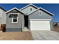 Charming home with a combination of brick and siding, complemented by a two-car garage and well-lit exterior at 3342 N Buchanan Way, Aurora, CO 80019