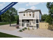 Two-story home with gray siding, white trim, small balcony, and minimal landscaping at 46565 Avery Ln, Bennett, CO 80022