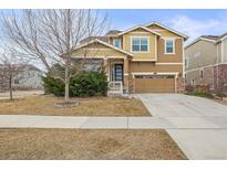 Charming two-story home with a well-maintained lawn, inviting curb appeal and attached two car garage at 844 Dakota Ln, Erie, CO 80516