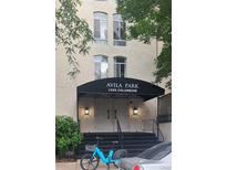 Building entrance with black awning, white double doors, and wrought iron railings at Avila Park, 1365 Columbine at 1365 Columbine St # 403, Denver, CO 80206