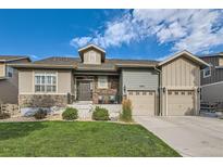Charming home featuring stone accents, a well-manicured lawn, and a two-car garage at 13645 Mariposa St, Broomfield, CO 80023