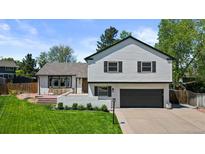 Charming two-story home with manicured lawn, white siding, and updated landscaping at 7633 S Gilpin Ct, Centennial, CO 80122