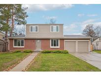 Charming two-story home with a well-manicured lawn and a two-car garage at 4623 S Kalispell Way, Aurora, CO 80015
