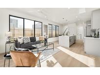 Bright living room features modern decor, large windows, and an open floor plan at 263 S Jackson St, Denver, CO 80209