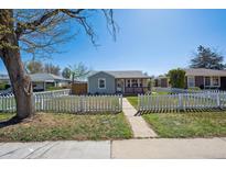 Charming single-story home with a white picket fence and well-maintained front yard at 1716 Fulton St, Aurora, CO 80010