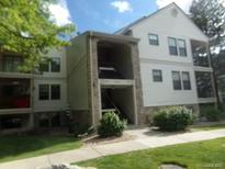 Inviting condo building featuring stone accents, a covered entry, and multiple levels of comfortable living at 6705 S Field St # 802, Littleton, CO 80128