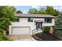 Charming two-story home featuring an attached garage and well-maintained landscaping at 13249 W Jewell Pl, Denver, CO 80228