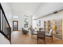 Bright, open living room features modern decor, wood floors, and lots of natural light at 3195 Blake St # 201, Denver, CO 80205