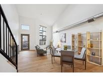 Spacious living room with hardwood floors, high ceilings, and large windows at 3195 Blake St # 201, Denver, CO 80205