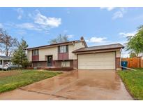 Charming home with a two-car garage, brick accents, and a well-maintained front yard at 12603 E Ohio Ave, Aurora, CO 80012