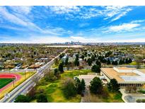 Distant skyline view from an aerial shot that overlooks a greenbelt area with city access at 7080 W 20Th Ave # 202, Lakewood, CO 80214