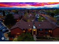 Exterior view of townhomes and mountain background at dusk at 7080 W 20Th Ave # 202, Lakewood, CO 80214