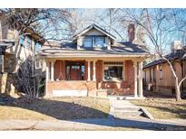 Brick home with inviting porch and landscaping at 536 S High St, Denver, CO 80209