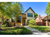Charming two-story home featuring modern wood and brick accents with a well-manicured front yard at 619 S High St, Denver, CO 80209