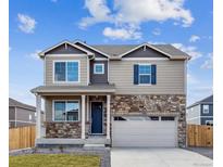 Charming two-story home with stone accents, a covered porch and a two-car garage at 6519 14Th St, Frederick, CO 80530