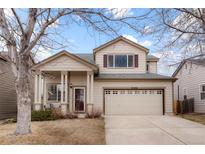 Inviting two-story home boasts a charming front porch and well-maintained landscaping at 3596 S Jebel Cir, Aurora, CO 80013