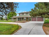 Charming two-story home featuring a long drive and three-car garage in a pastoral setting at 15545 Lipan St, Broomfield, CO 80023