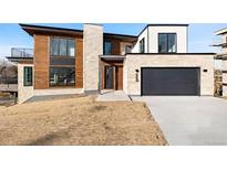 Stunning modern home with a stone and wood facade and a spacious two-car garage at 5392 Lions Paw St, Castle Rock, CO 80104